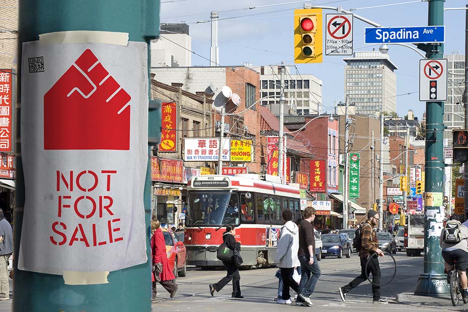 AHA Not for sale! poster taped to traffic poll on busy street in Toronto.